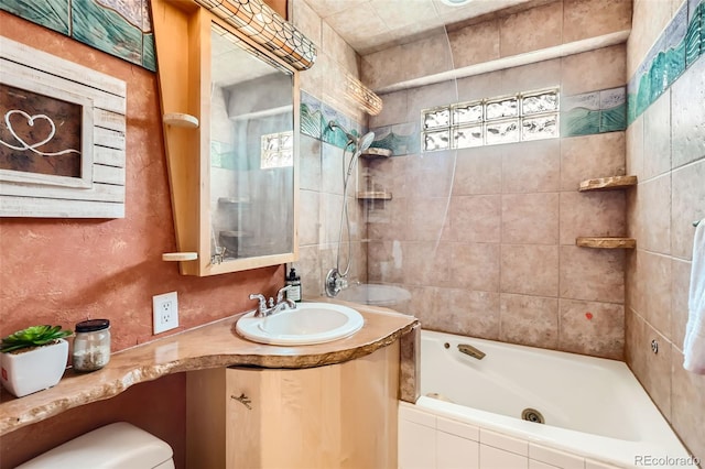 full bathroom featuring tiled shower / bath combo, vanity, and toilet