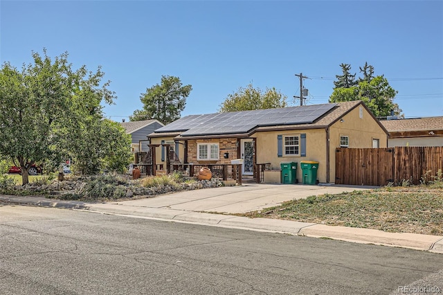 view of front of property featuring solar panels and covered porch