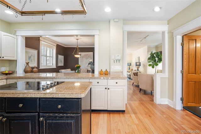 kitchen featuring black electric cooktop, tile countertops, dark cabinets, white cabinets, and light wood-style floors