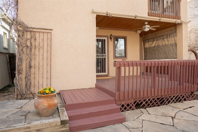 wooden terrace with a ceiling fan