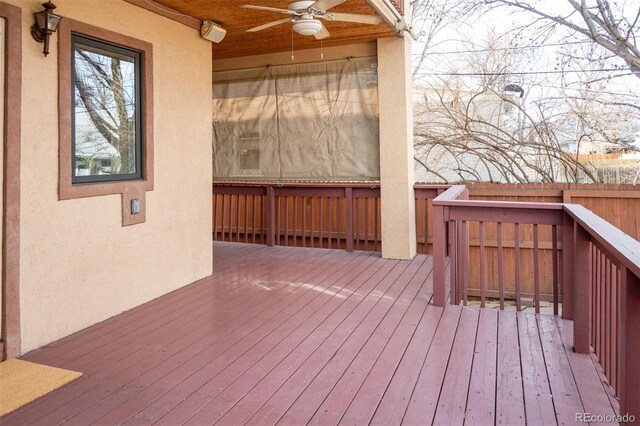 deck with a ceiling fan and fence