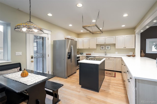 433 N Ogden St, Denver, CO 80218 - kitchen with stainless steel fridge with ice dispenser, a sink, light countertops, light wood finished floors, and pendant lighting