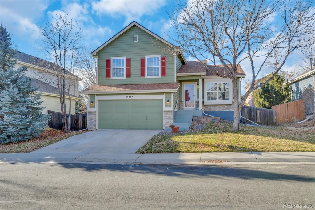 view of front of property with a garage and a front lawn