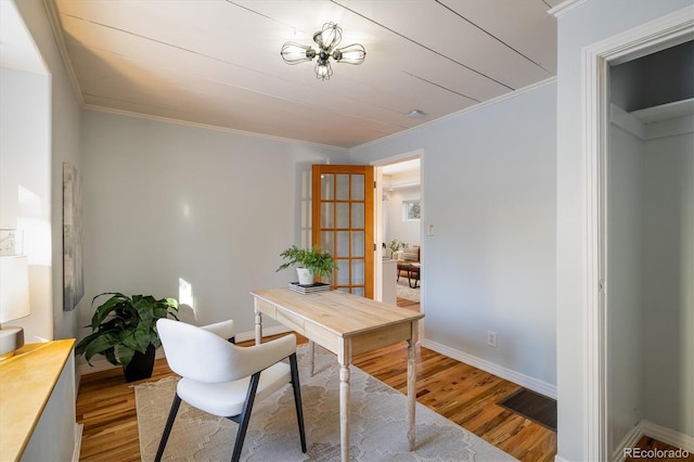 office area with crown molding and light hardwood / wood-style flooring