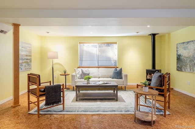 living area featuring carpet and a wood stove