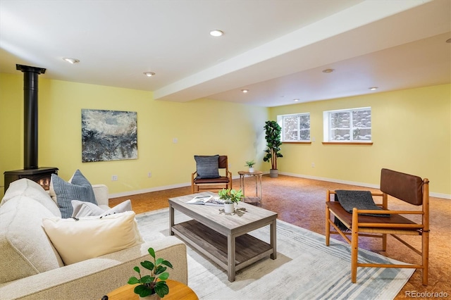 living room featuring a wood stove and light colored carpet