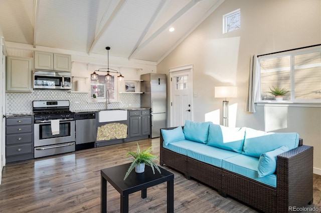 living room featuring dark hardwood / wood-style flooring, sink, beam ceiling, and high vaulted ceiling