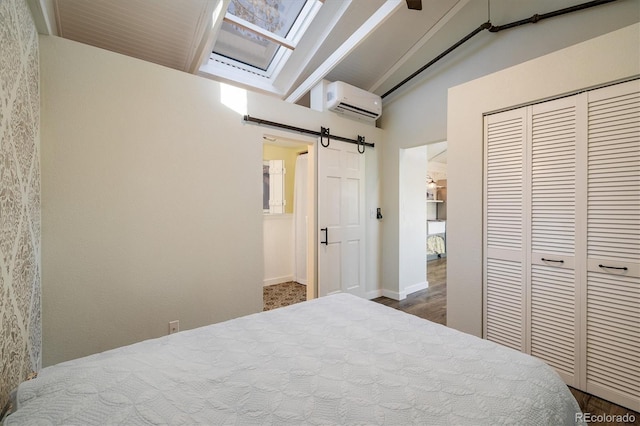 bedroom featuring lofted ceiling, a wall unit AC, a barn door, dark hardwood / wood-style flooring, and a closet