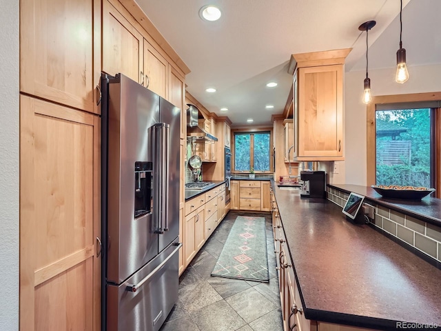 845 Urban St, Lakewood, CO 80401 - kitchen with appliances with stainless steel finishes, light brown cabinetry, dark countertops, recessed lighting, and pendant lighting