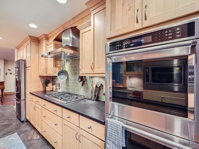 845 Urban St, Lakewood, CO 80401 - kitchen with wall chimney range hood, appliances with stainless steel finishes, light brown cabinets, dark countertops, and recessed lighting