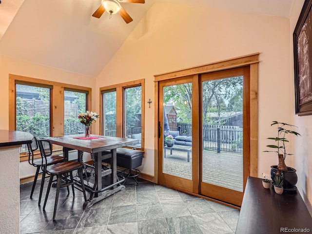 845 Urban St, Lakewood, CO 80401 - dining area with healthy amount of natural light, ceiling fan, high vaulted ceiling, baseboards, and stone finish floors