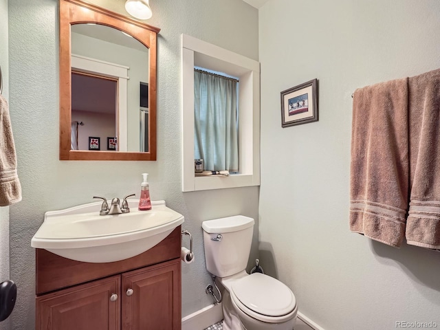 845 Urban St, Lakewood, CO 80401 - half bathroom with vanity, toilet, and baseboards