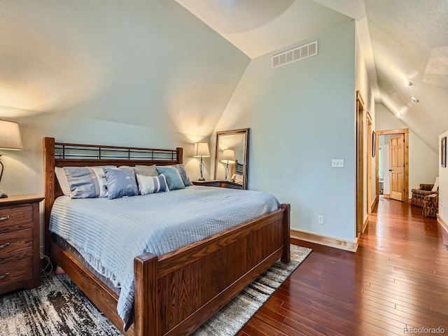 845 Urban St, Lakewood, CO 80401 - bedroom featuring vaulted ceiling, dark wood-style flooring, and baseboards