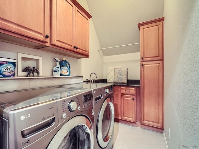 845 Urban St, Lakewood, CO 80401 - laundry room featuring cabinet space, washing machine and clothes dryer, a textured wall, and light tile patterned floors