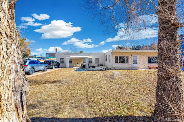 rear view of property with a yard