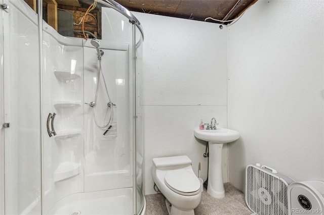 bathroom featuring toilet and a shower with shower door