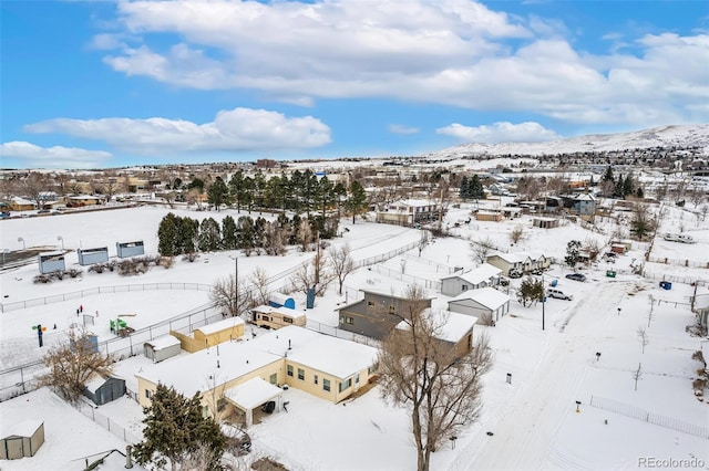 snowy aerial view featuring a mountain view