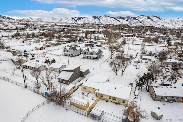 snowy aerial view featuring a residential view and a mountain view