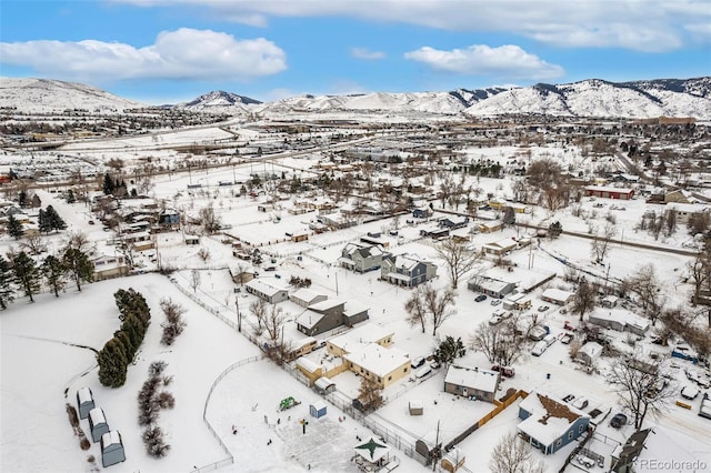 snowy aerial view featuring a mountain view