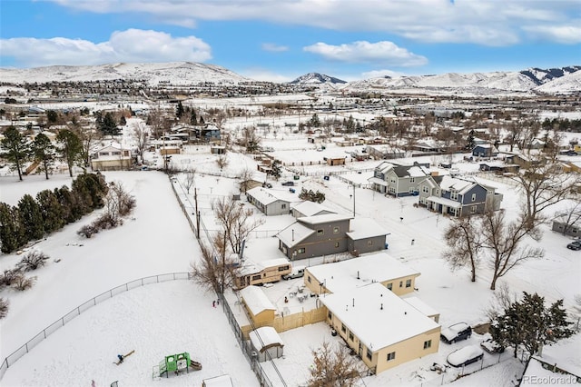 snowy aerial view with a mountain view