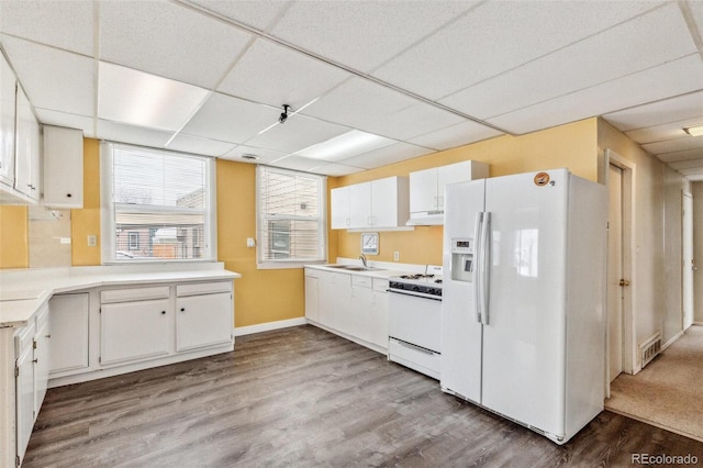 kitchen with visible vents, light countertops, light wood-style flooring, white cabinets, and white appliances