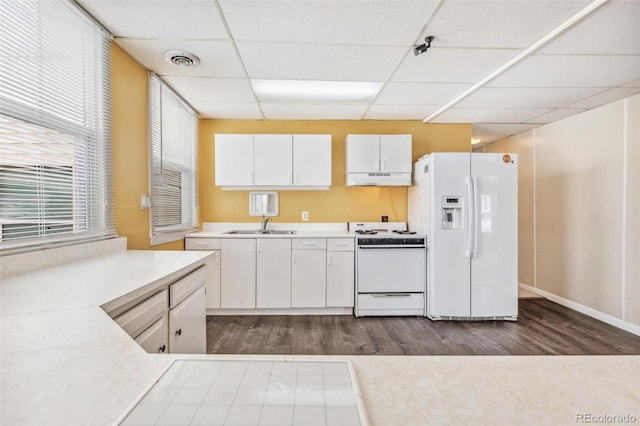 kitchen featuring white appliances, visible vents, white cabinets, light countertops, and under cabinet range hood