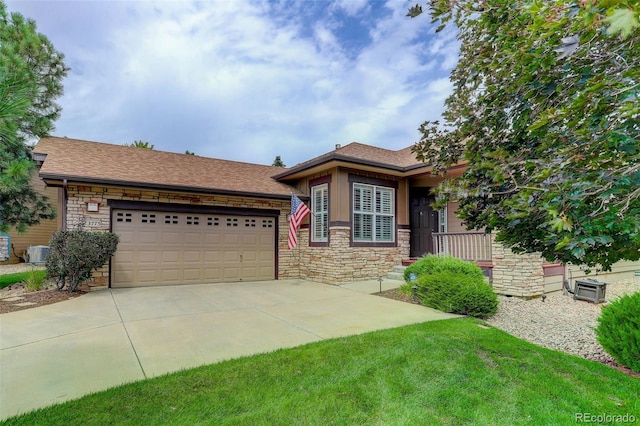 view of front facade featuring central AC, a garage, and a front lawn