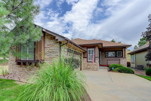 view of front of home featuring a garage and central AC unit