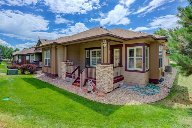 exterior space featuring central air condition unit and a lawn