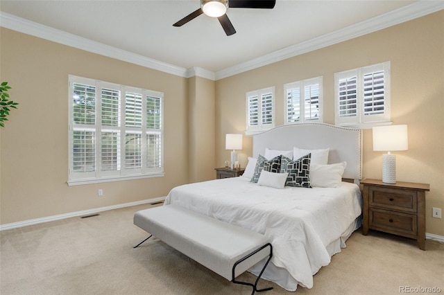 carpeted bedroom with ceiling fan and ornamental molding