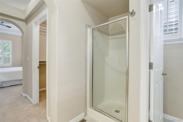 bathroom featuring a shower with door