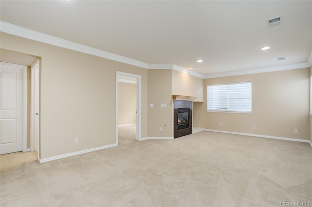 unfurnished living room with ornamental molding and light carpet