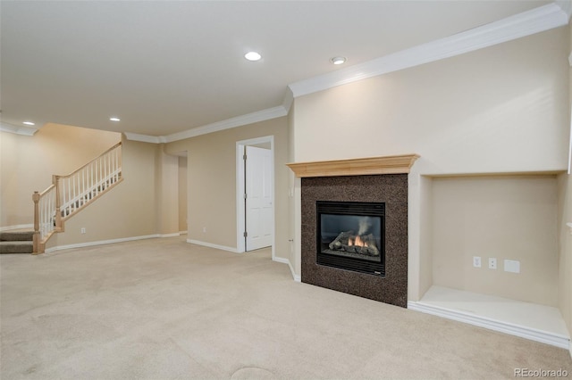 unfurnished living room featuring carpet flooring, ornamental molding, and a fireplace