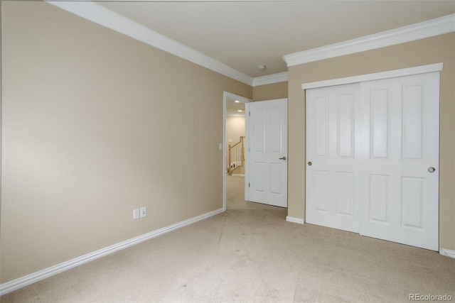 unfurnished bedroom with carpet, ornamental molding, and a closet