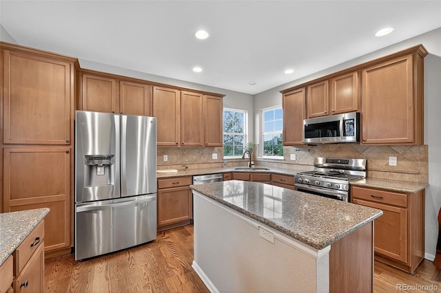 14620 Prairie Sky Ln, Broomfield, CO 80023 - kitchen with appliances with stainless steel finishes, light wood-style flooring, light stone countertops, and recessed lighting