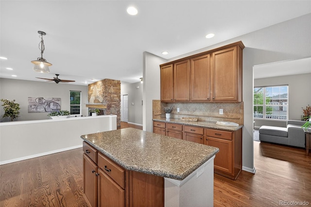14620 Prairie Sky Ln, Broomfield, CO 80023 - kitchen with open floor plan, a ceiling fan, brown cabinets, dark wood-style flooring, and recessed lighting