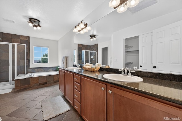 14620 Prairie Sky Ln, Broomfield, CO 80023 - bathroom with a stall shower, double vanity, a bath, tile patterned floors, and a walk in closet