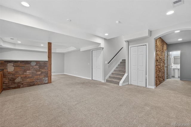 14620 Prairie Sky Ln, Broomfield, CO 80023 - unfurnished living room featuring carpet flooring, recessed lighting, stairs, arched walkways, and a raised ceiling