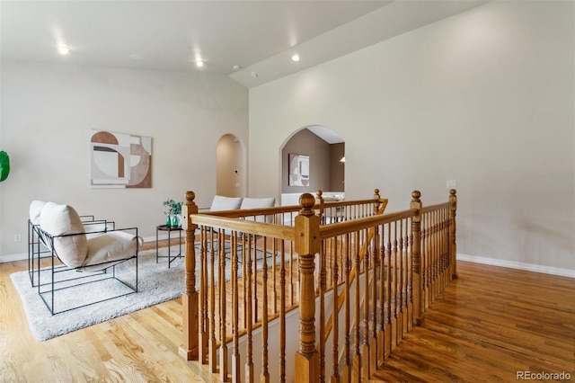 19770 Roaming Dr, Colorado Springs, CO 80908 - staircase featuring wood finished floors, arched walkways, recessed lighting, and high vaulted ceiling