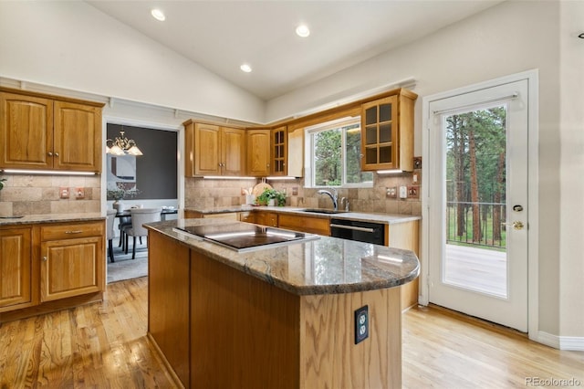 19770 Roaming Dr, Colorado Springs, CO 80908 - kitchen with black appliances, lofted ceiling, light wood finished floors, a center island, and stone counters