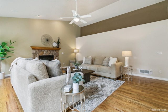 19770 Roaming Dr, Colorado Springs, CO 80908 - living area with ceiling fan, wood finished floors, and a fireplace