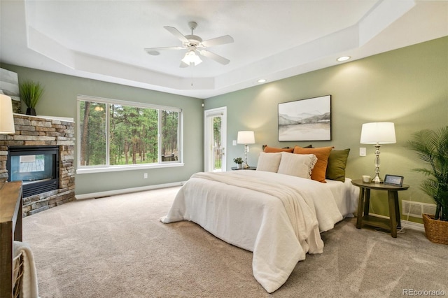 19770 Roaming Dr, Colorado Springs, CO 80908 - bedroom with carpet, a raised ceiling, a fireplace, ceiling fan, and recessed lighting