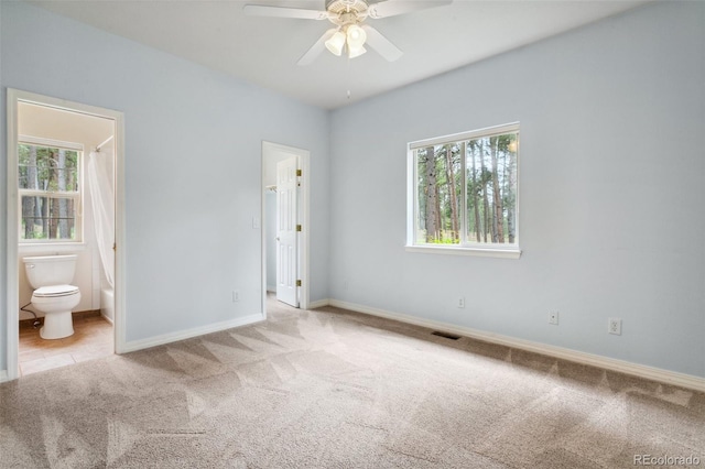 19770 Roaming Dr, Colorado Springs, CO 80908 - unfurnished bedroom with carpet floors, multiple windows, ensuite bathroom, and a walk in closet