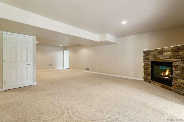 19770 Roaming Dr, Colorado Springs, CO 80908 - unfurnished living room with a stone fireplace, light carpet, and recessed lighting