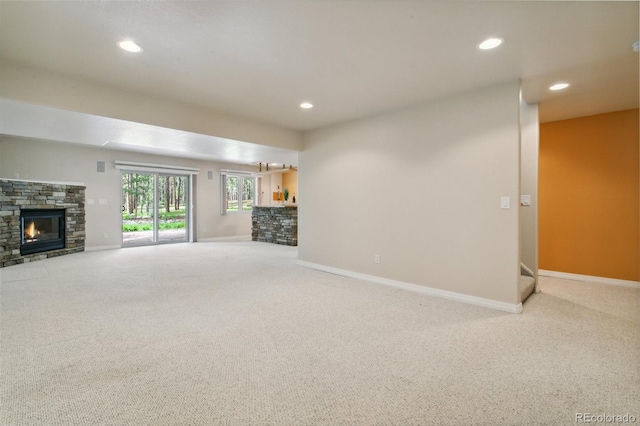 19770 Roaming Dr, Colorado Springs, CO 80908 - unfurnished living room with carpet, a stone fireplace, and recessed lighting