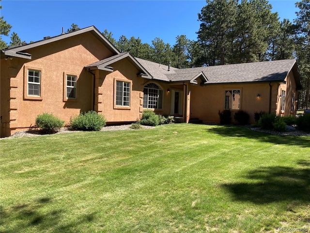 19770 Roaming Dr, Colorado Springs, CO 80908 - single story home with a front lawn and stucco siding