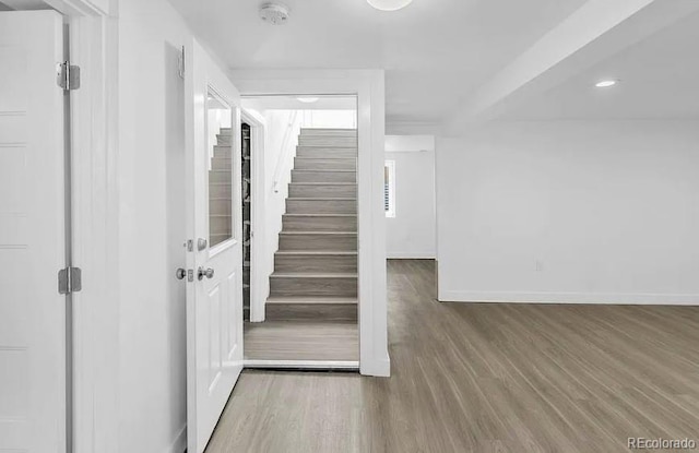 entrance foyer with stairs, recessed lighting, wood finished floors, and baseboards