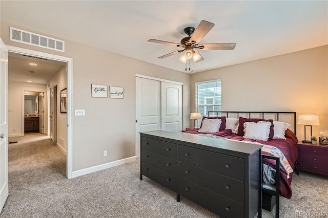 bedroom featuring light colored carpet, a closet, and ceiling fan