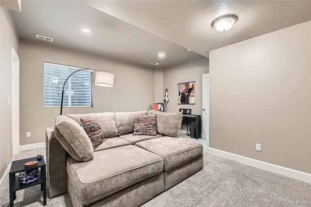 living room with carpet flooring and a textured ceiling