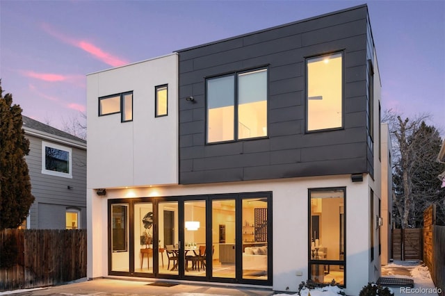 back house at dusk with a patio